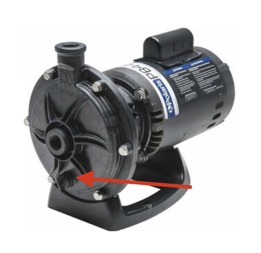 Cleaner booster pump with drain plug marked by arrow