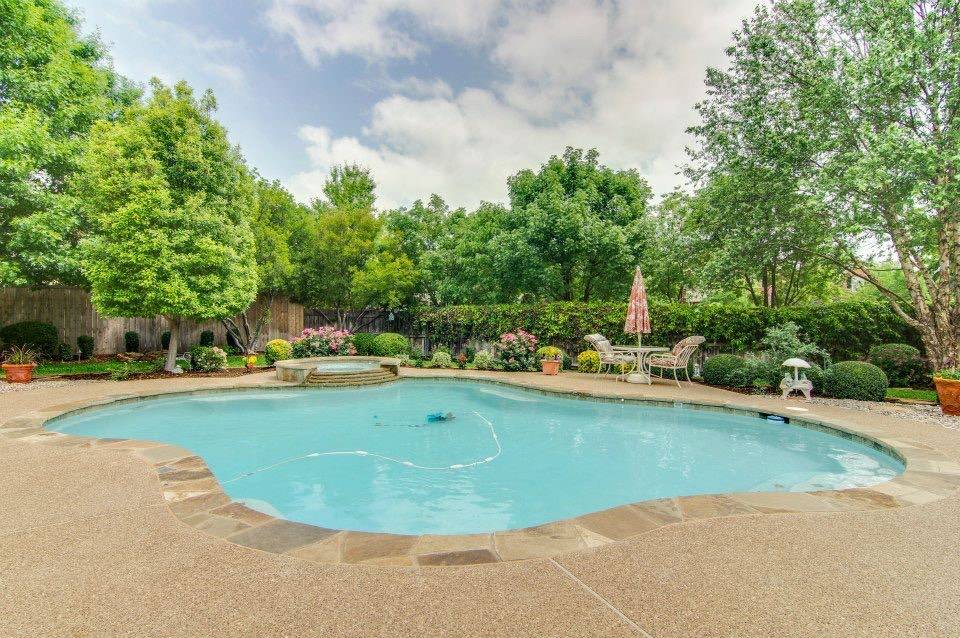 Euless backyard pool with lush landscaping