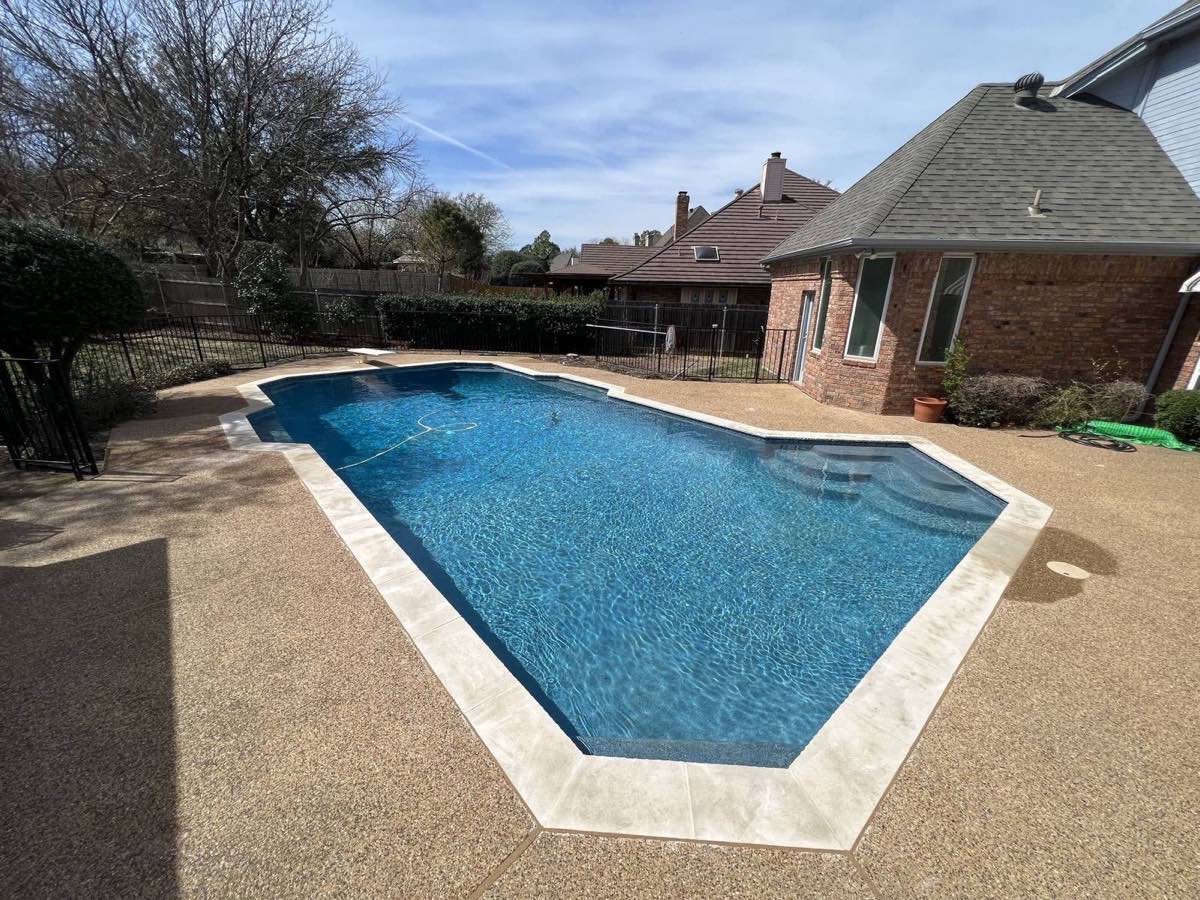Coppell backyard pool with travertine coping