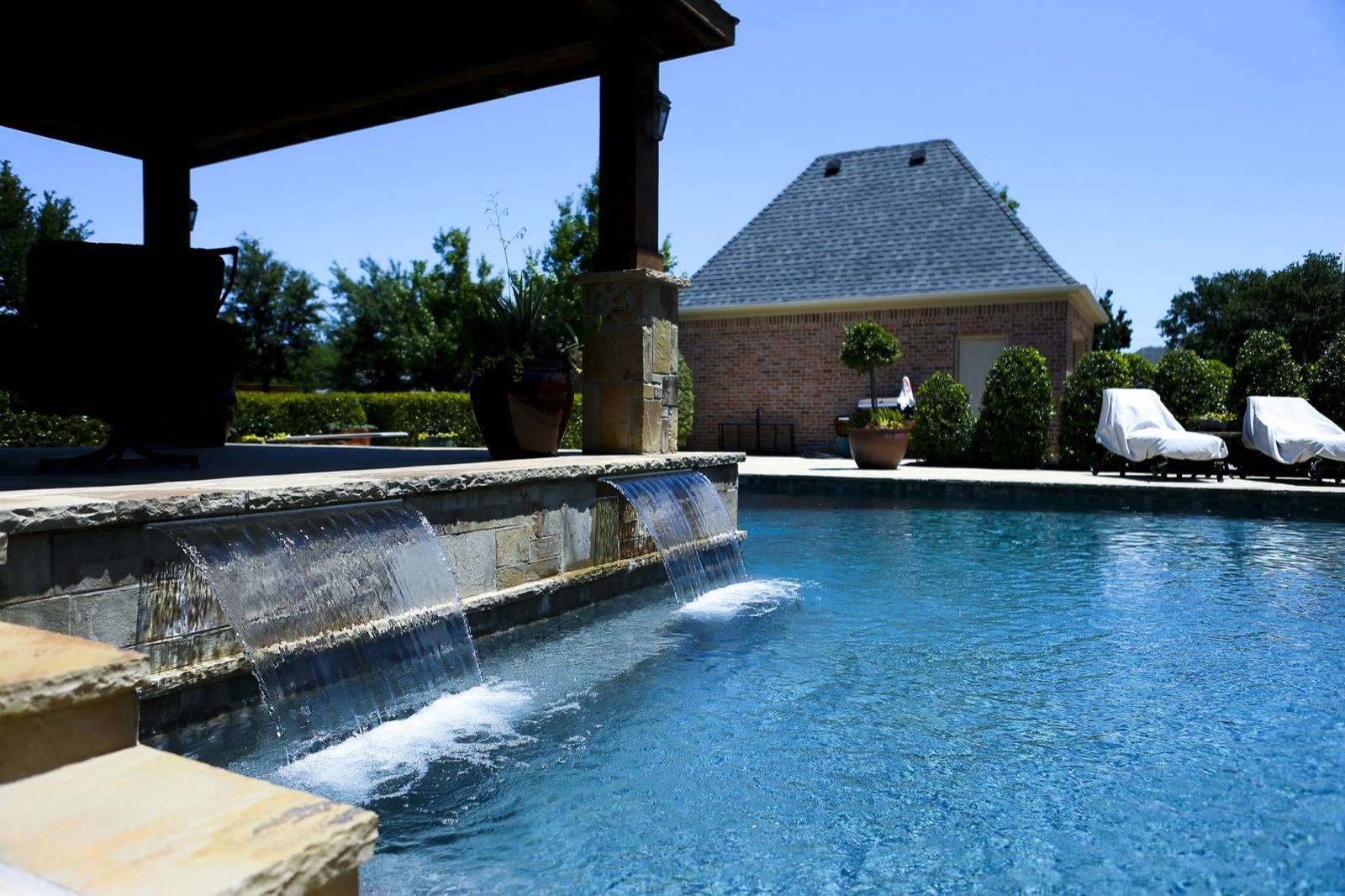 Grapevine-area pool with raised wall and scuppers