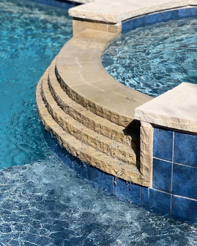 Curved stone steps into remodeled spa