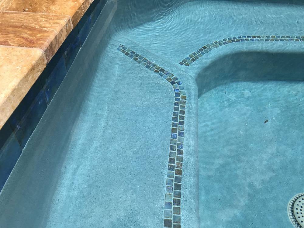 Pool steps with mosaic tile trim